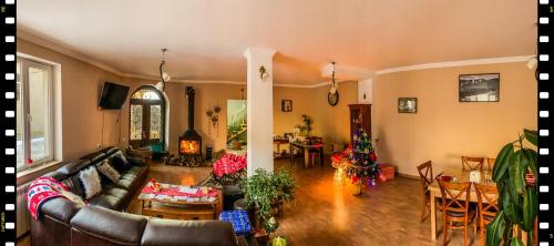 a living room with a couch and a table at Family Hotel Kala in Mestia