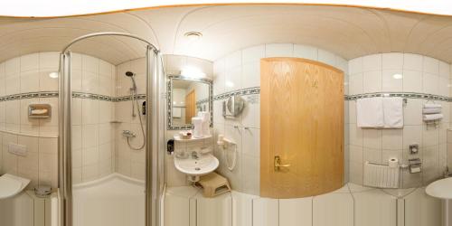 a bathroom with a shower and a sink at Hotel-Restaurant Sonnhof in Radfeld