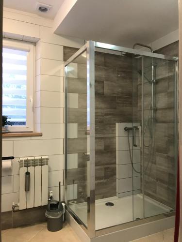 W łazience z oknem znajduje się przeszklony prysznic. w obiekcie Mieszkanie u Tomka INPIW02 w mieście Piwniczna
