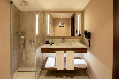 a bathroom with a sink and a shower at Dorukkaya Ski & Mountain Resort in Kartalkaya