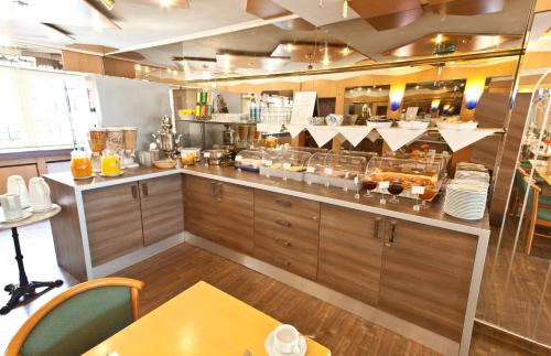 a large kitchen with a counter with at Hotel Primus Frankfurt Sachsenhausen in Frankfurt/Main