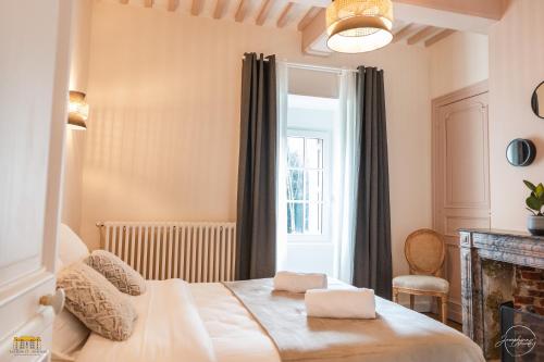 a bedroom with a bed and a window at Château d'Hermival in Hermival-les-Vaux