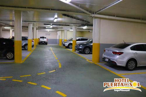 a parking garage with several cars parked in it at Hotel Puerta del Sol in David