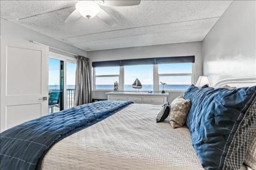 a bedroom with a bed with a view of the ocean at Amelia By The Sea in Fernandina Beach