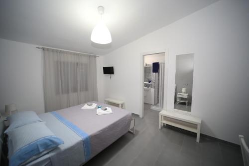 a hotel room with a bed and a mirror at B&B Umballa in Praia a Mare