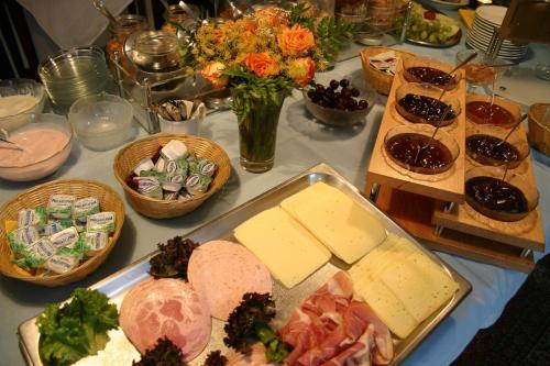 a table with cheese and other foods on it at Gasthof Oldenwöhrden in Wöhrden