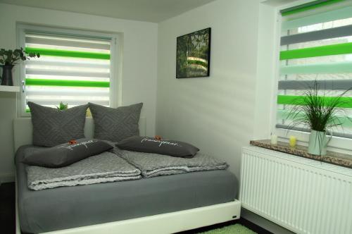 a bedroom with a bed with pillows and a window at Ferienwohnung Haus Felix in Bad Elster