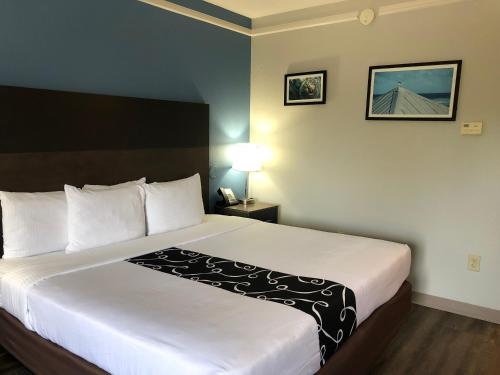 a bedroom with a large bed in a hotel room at La Quinta by Wyndham PCB Coastal Palms in Panama City Beach