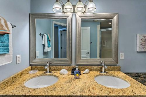 a bathroom with two sinks and a large mirror at Bright Beachfront PCB Unit Balcony and Beach Chairs in Panama City Beach