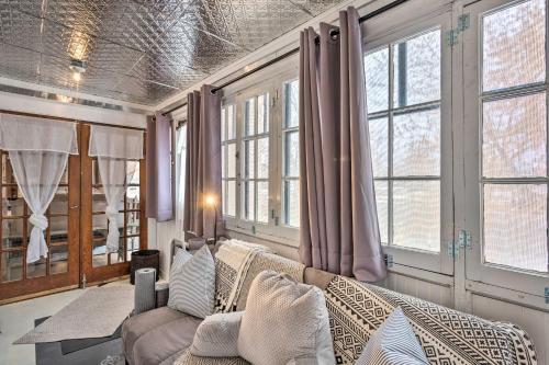 a living room with a couch and some windows at Lovely Montrose Home with Yard Walk to Dtwn and Park! in Montrose