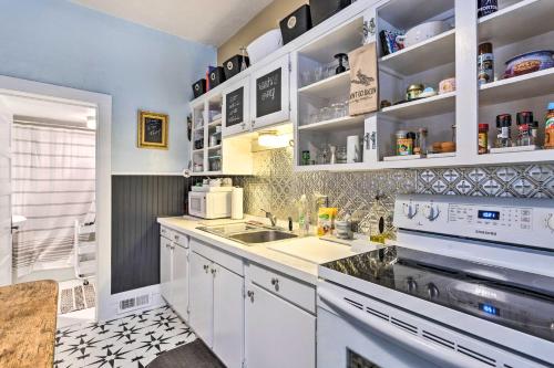 a kitchen with white cabinets and a sink at Lovely Montrose Home with Yard Walk to Dtwn and Park! in Montrose