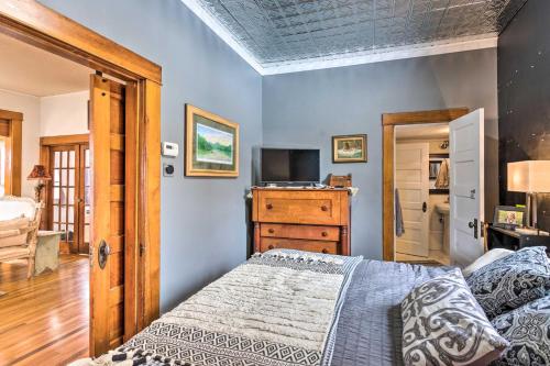 a bedroom with a bed and a dresser with a television at Lovely Montrose Home with Yard Walk to Dtwn and Park! in Montrose