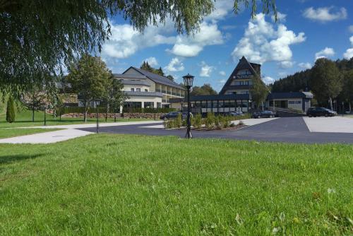 a building with a street light in the grass at Hotel Haus Tiefenbach in Bullange