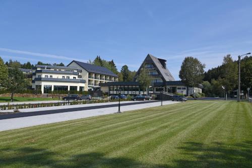 a street with houses and a field of grass at Hotel Haus Tiefenbach in Bullange