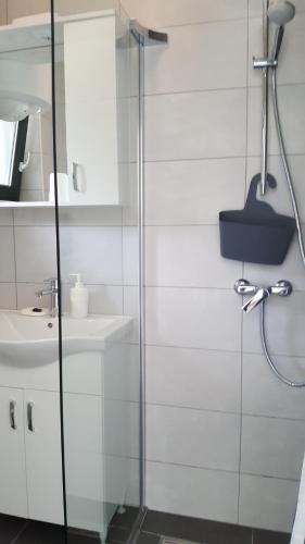 a bathroom with a shower and a sink at Apartments ARTEMIS in Baška