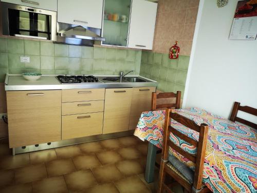 a kitchen with a sink and a stove at Eureka Azienda Agrituristica in Cavallino-Treporti