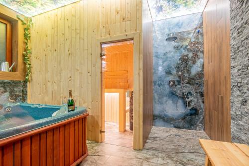 a bathroom with a tub and a glass wall at U Repy in Bańska