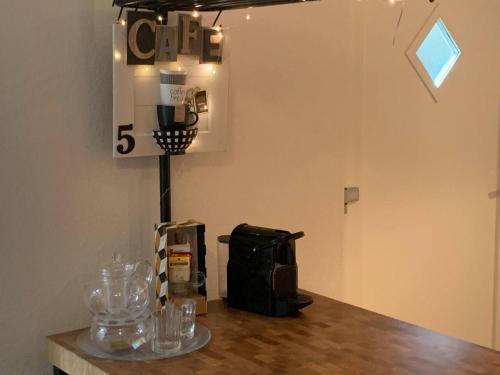 a room with a counter with glasses on a table at Charming 2-Bed Apartment in Arlesheim 15 min Basel in Arlesheim