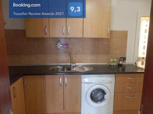 a kitchen with a sink and a washing machine at Casa Mila in Puerto del Rosario