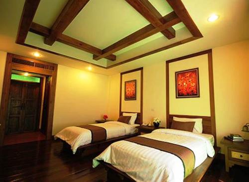 Un pat sau paturi într-o cameră la Villa Korbhun Khinbua