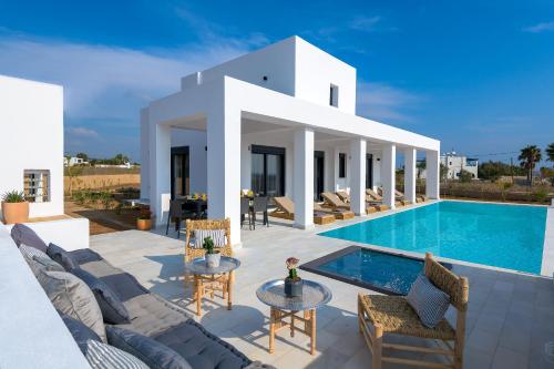 a villa with a swimming pool and a patio at Seawater Villa in Lachania