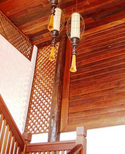 a wooden ceiling with two lights hanging from it at Villa Korbhun Khinbua in Chiang Mai