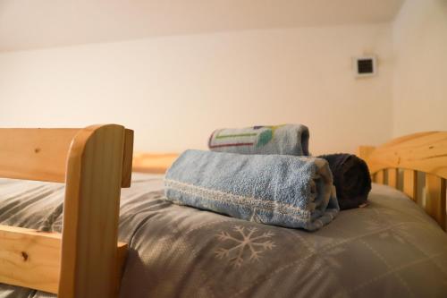 a bed with a blanket on top of it at COL DE RIF Appartamento Storico nelle Dolomiti in Falcade