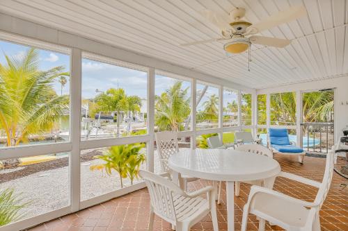a white dining room with a table and chairs at Sapphire Sabbatical in Key West