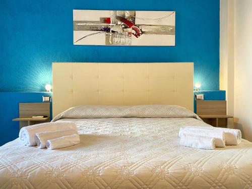 a bedroom with a bed with two towels on it at Gioia Guesthouse in Càbras