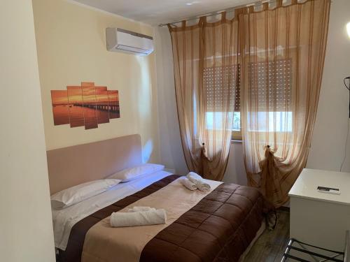 a bedroom with a bed and a window at BONORUM De Spuches in Palermo