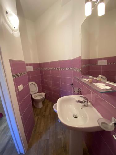 a bathroom with a sink and a toilet and a mirror at BONORUM De Spuches in Palermo