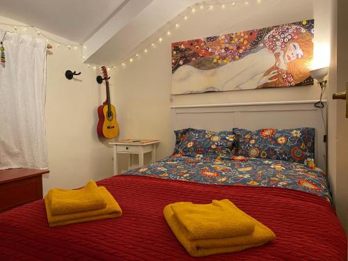 a bedroom with a bed with two yellow towels on it at Cosy Cottage in Durham City in Durham