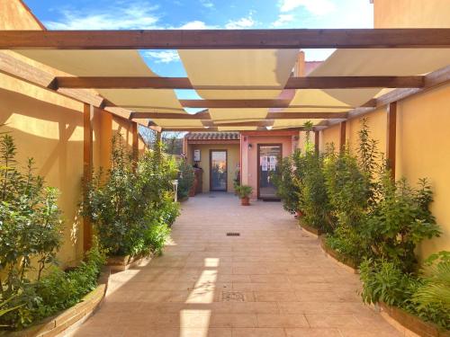 a hallway of a building with awnings and plants at Gioia Guesthouse in Càbras