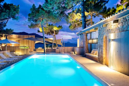 a swimming pool in the backyard of a house at La Plage Casadelmar in Porto-Vecchio