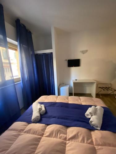 a bedroom with a large bed with towels on it at BONORUM De Spuches in Palermo