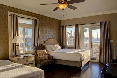 a bedroom with two beds and a ceiling fan at Casablanca Inn on The Beach in Santa Cruz