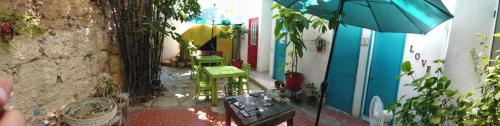a patio with chairs and an umbrella in a house at La Casa del Barrio in Monterrey