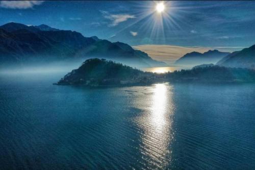 a view of a body of water with the sun in the sky at Bellagio Holiday Home in Bellagio