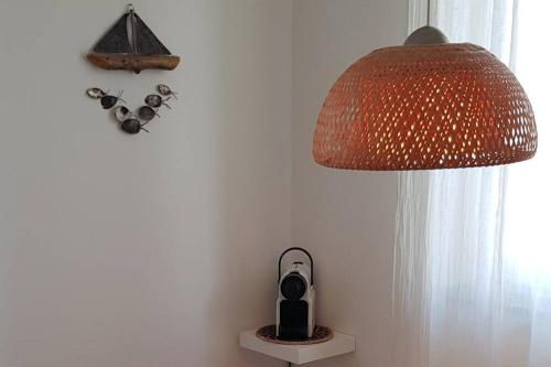 a lamp and a clock on a wall next to a window at Bellagio Holiday Home in Bellagio