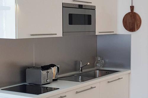 a kitchen with a sink and a microwave at Bellagio Holiday Home in Bellagio