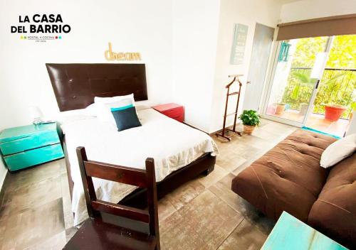 a bedroom with a bed and a couch at La Casa del Barrio in Monterrey