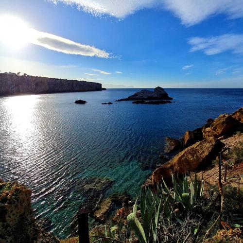 a view of a large body of water with rocks at SCRUSCIU HOME in Terrasini