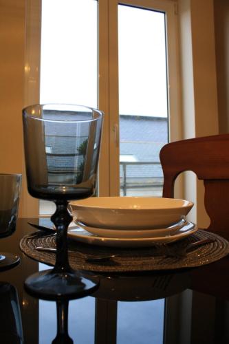 a table with a plate and a wine glass on it at Los Balcones del Arte in Santander