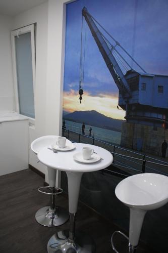 a white table with two cups on top of a building at Los Balcones del Arte in Santander