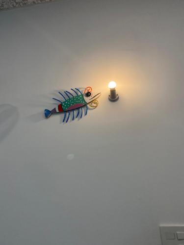 a candle sitting on the floor next to a light at Cát Homestay in Quy Nhon