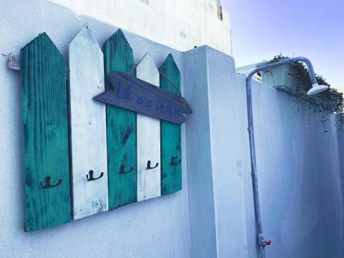 a building with green doors and a sign on it at Cát Homestay in Quy Nhon