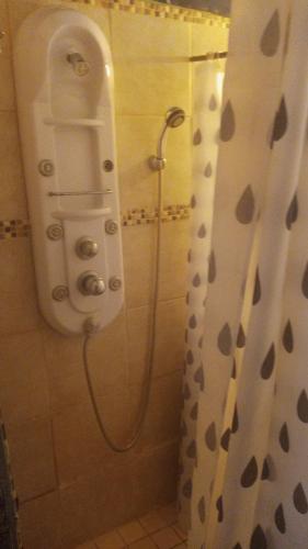 a shower in a bathroom with a shower curtain at CHEZ NOUS in Carrillo