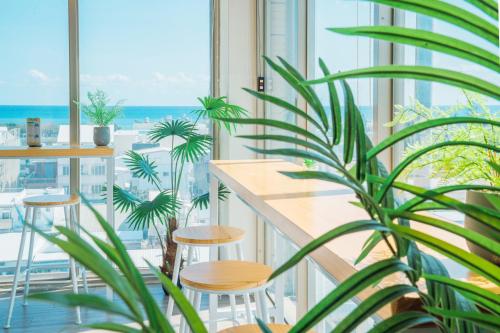 a balcony with a table and stools and a view of the ocean at Fun Trip - Fu May Sea View Holiday house l 無敵海景交誼廳 l 附汽機車租賃 l in Taitung City