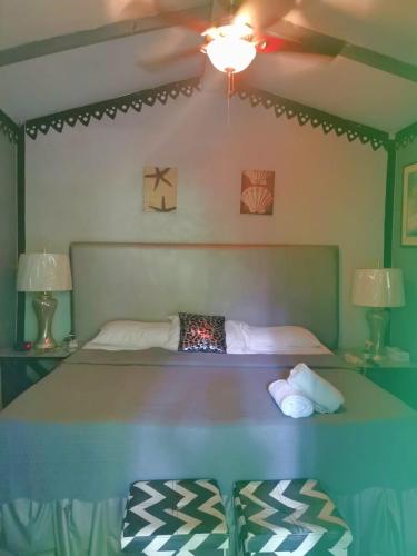 a bedroom with a bed with a ceiling fan at CHEZ NOUS in Carrillo