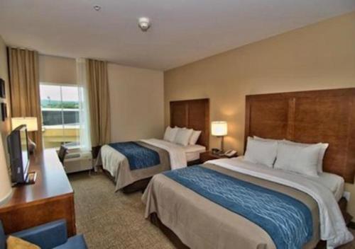 a hotel room with two beds and a television at Comfort Inn Apalachin - Binghamton W Route 17 in Apalachin
